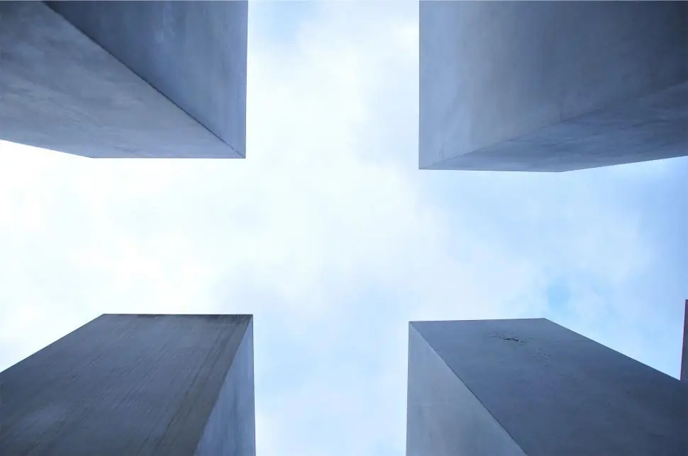 Four modern pillars against a blue sky